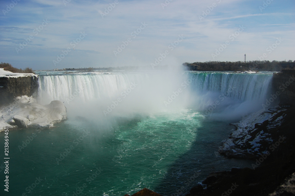 Fototapeta premium Niagara Falls under rainbow in early spring, New York State, USA.