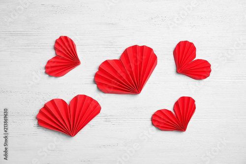 Small paper hearts on wooden background  top view