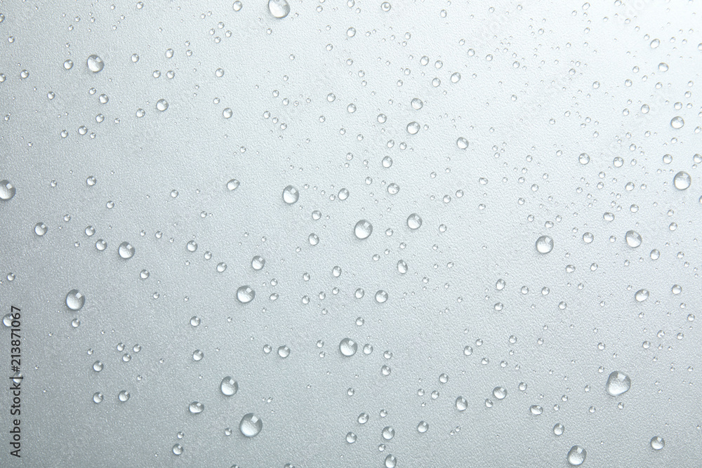 Many clean water drops on grey background
