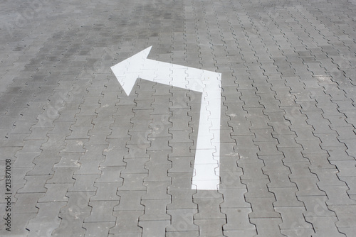 White arrow down on street tile