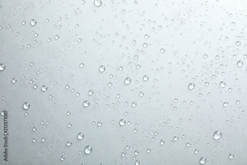 Many clean water drops on grey background photo