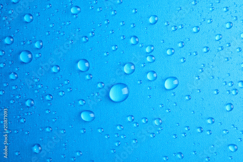 Many clean water drops on color background