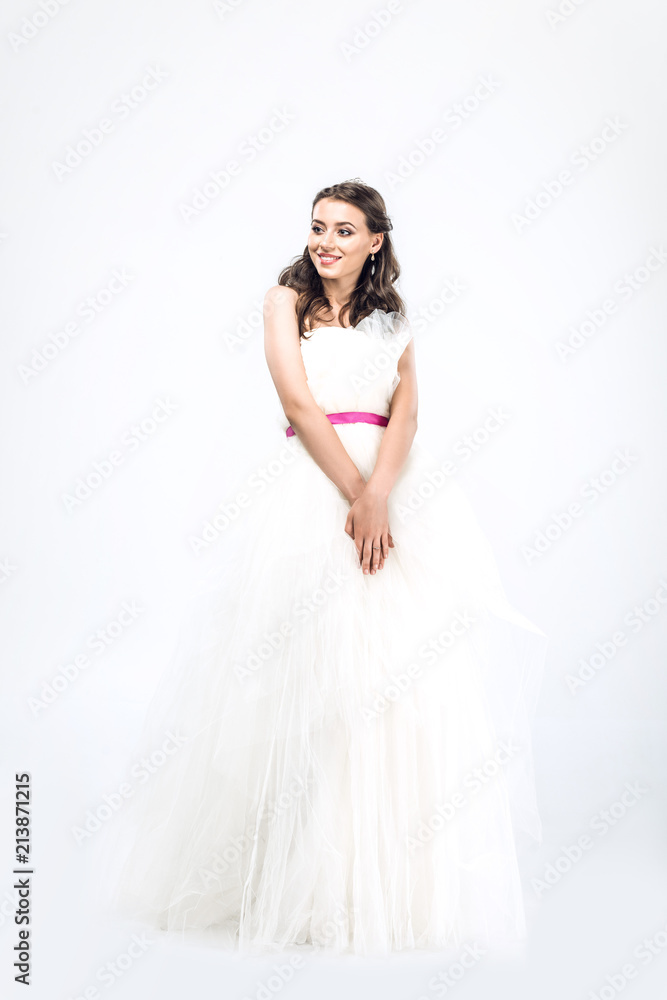 smiling young bride in wedding dress on white smiling young bride in wedding dress on white