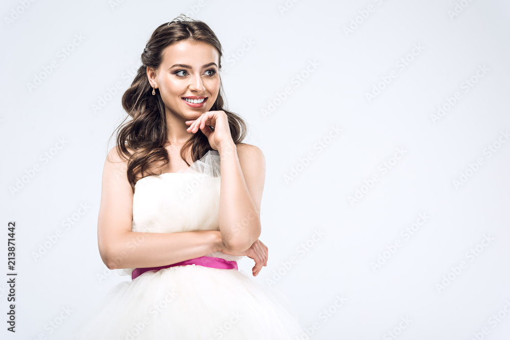 smiling young bride in wedding dress looking away isolated on white smiling young bride in wedding dress looking away isolated on white