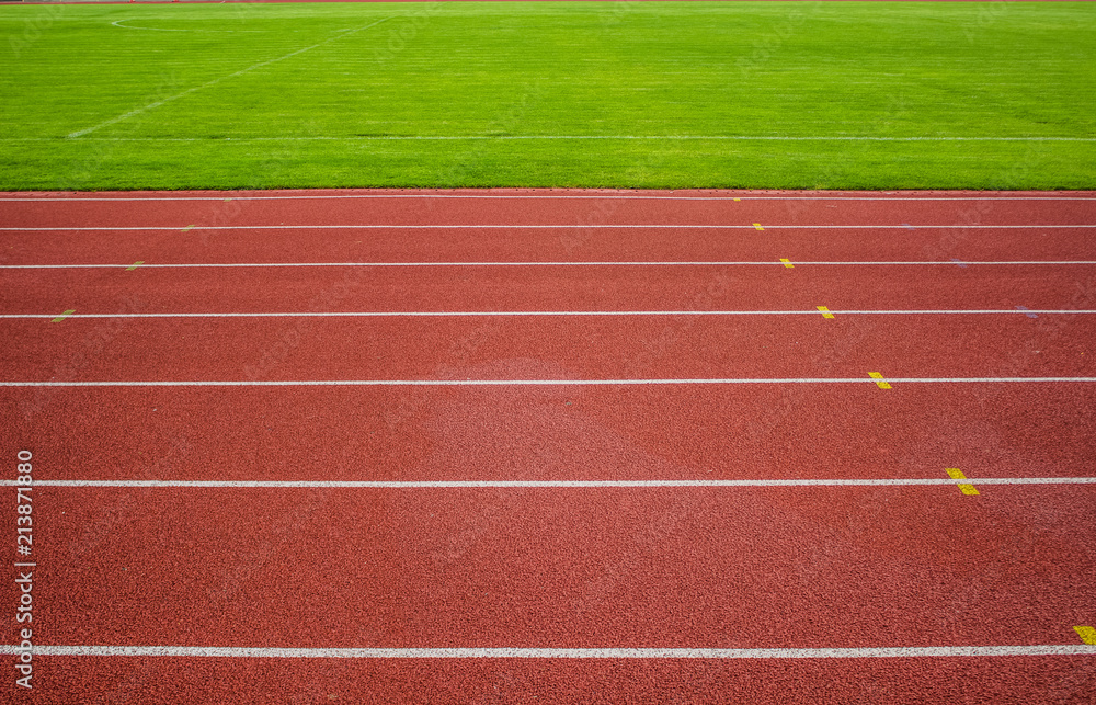 red running track background texture with white marking lanes and empty space for copy or text