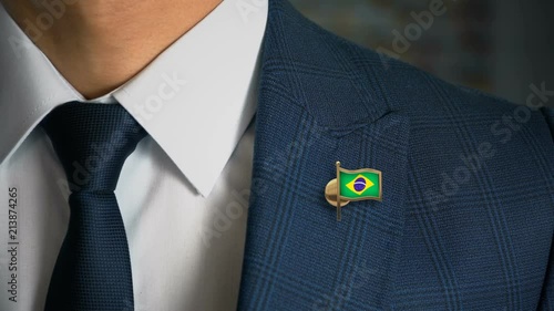 Businessman Walking Towards Camera With Country Flag Pin - Brazil