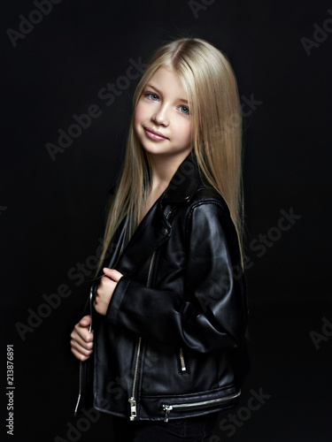 Portrait of the beautiful child on black background