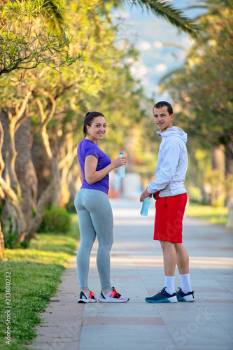 Urban sports, healthy young couple jogging in the city at sunny morning