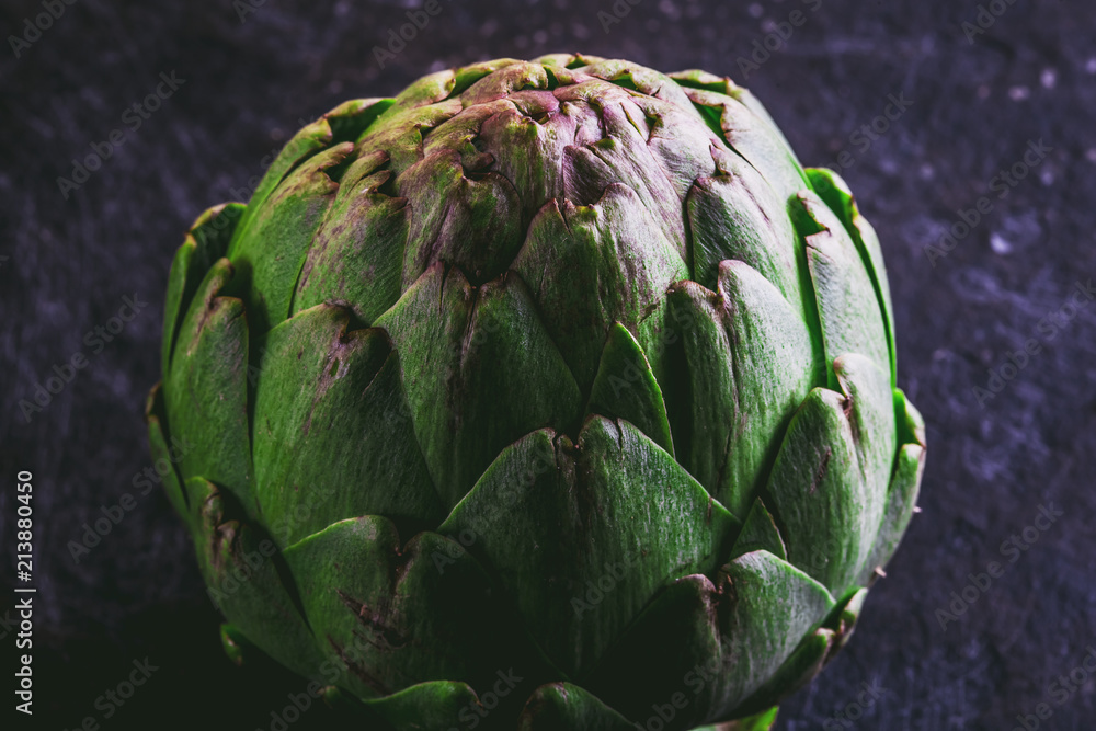 Fototapeta premium ARTICHOKE. Close up of artichoke, top view, dark background. Macro