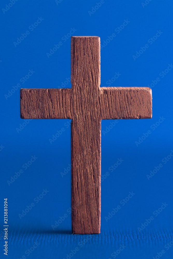 A Simple Wooden Cross on a Blue Background