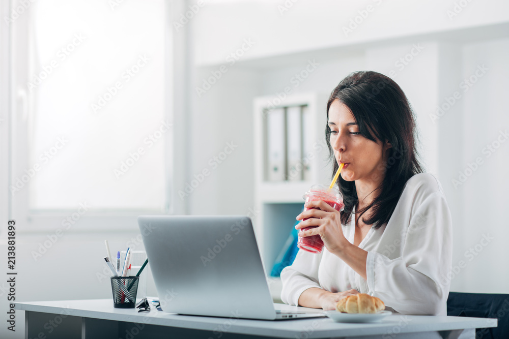 Attractive Woman Drinking Smoothie at the Office Attractive Woman Drinking Smoothie at the Office