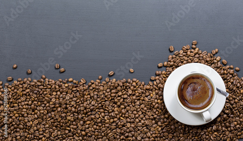 coffee cups on coffee beans  black textured wooden table