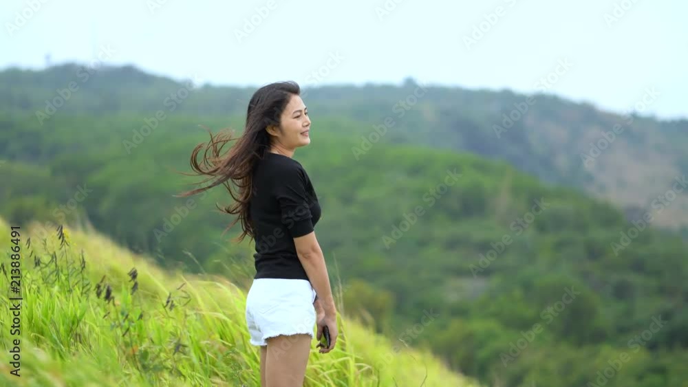 Asian women happily standing on the green fields. Asian women happily standing on the green fields.