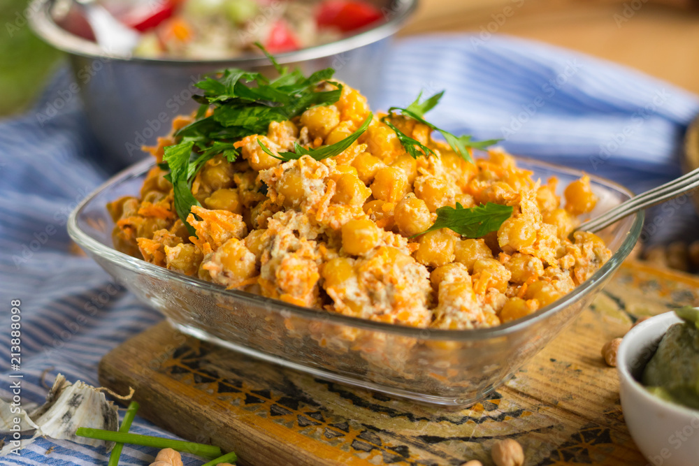 Indian chickpea salad with grated carrot, onion, garlic paste, tahini sesame seeds paste and fresh green herbs. Vegan, vegetarian healthy food. Indian chickpea salad with grated carrot, onion, garlic paste, tahini sesame seeds paste and fresh green herbs. Vegan, vegetarian healthy food.