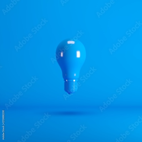 Levitating Blue Lightbulb floating on blue background color. minimal idea concept.