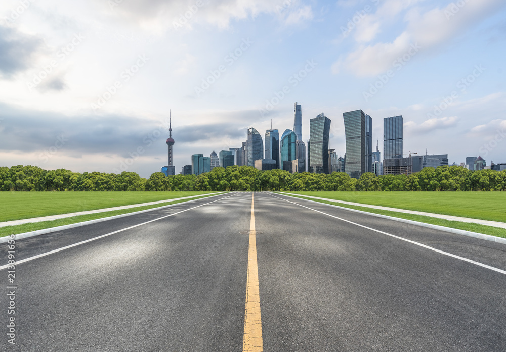 empty asphalt road through the shanghai skyline in China empty asphalt road through the shanghai skyline in China