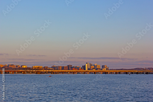 Sunrise over Virginia side of the Potomac River in Washington DC, USA. City panorama on a chilly spring morning with kayakers testing the river waters. © avmedved