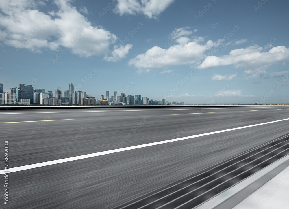 blurren asphalt road with city skyline background in china