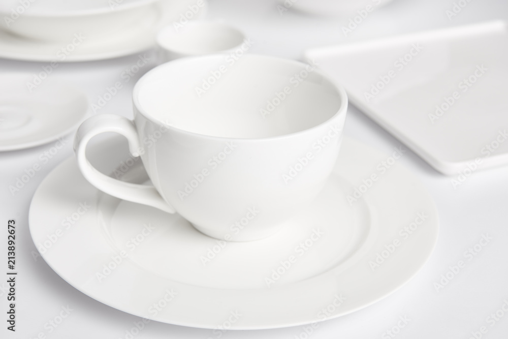 selective focus of plates and bowl on white tabletop