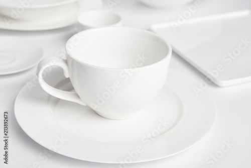 selective focus of plates and bowl on white tabletop