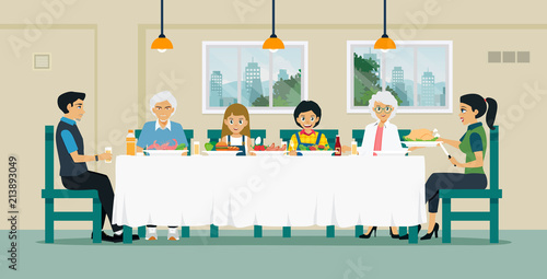 Families sit together to eat food on the table with grandfather and grandmother.