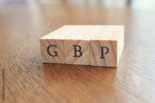 GBP (Great Britain Pound) Text Block on Wooden Table