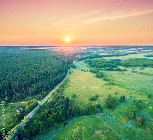 Fototapeta Naklejka Na Ścianę i Meble -  Aerial drone view of countryside, rural landscape with cloudy sky at sunset