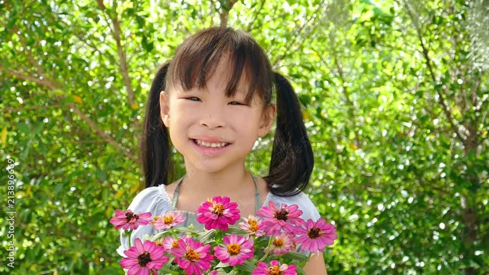 Little asian girl holding flower pot and smiles,slow motion.
Little asian girl holding flower pot and smiles,slow motion.