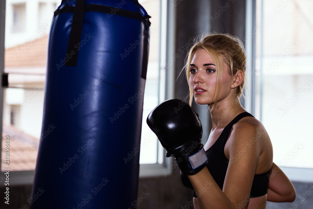 Young girl training with boxing glove.