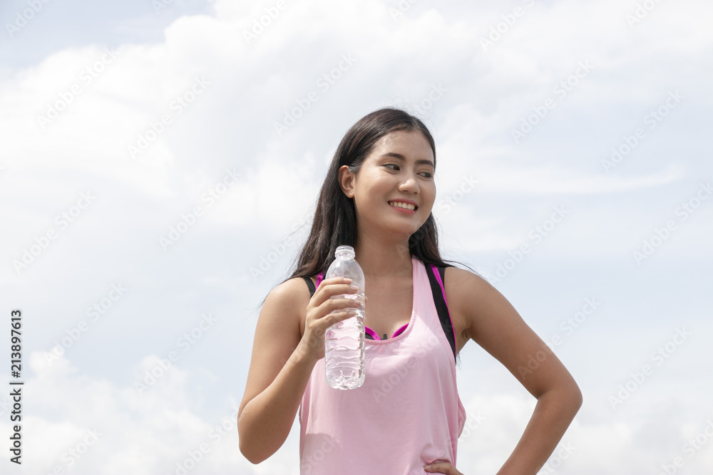 Thirsty woman is drinking water from bottle. Thirsty woman is drinking water from bottle.