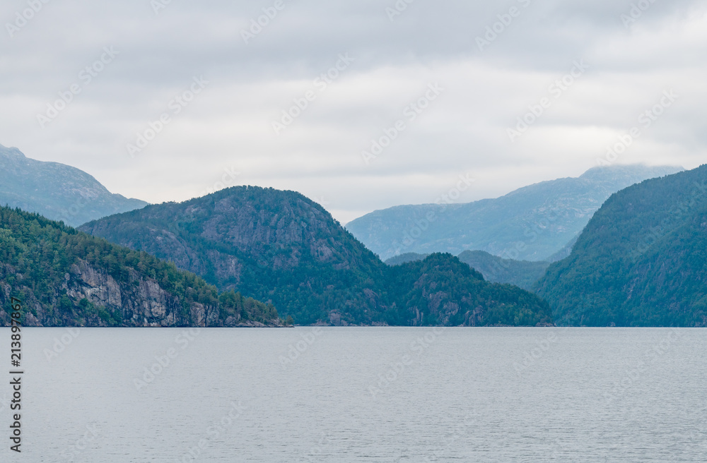 Mountain landscape of the fjord on a cloudy day.  A multi-planed landscape. Monstraumen, Hordaland country, Norway, Europe.