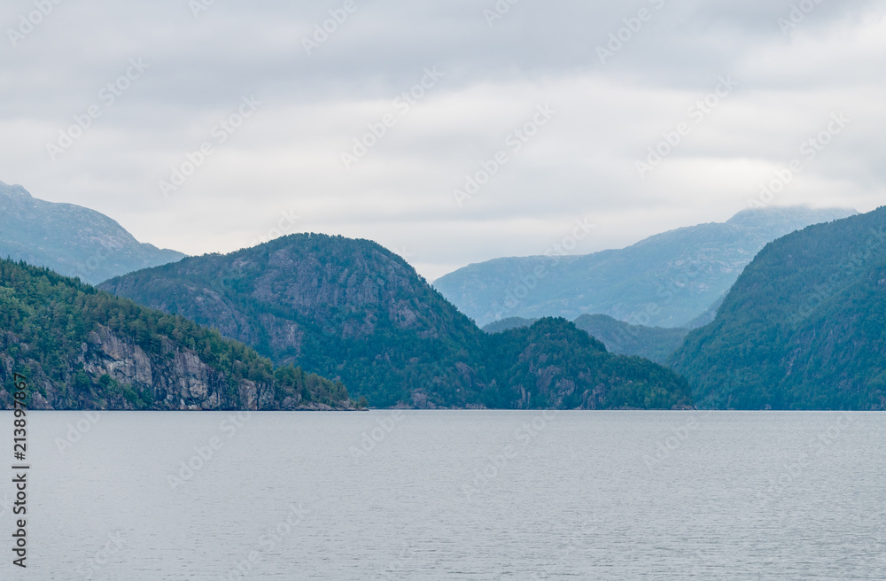 Obraz premium Mountain landscape of the fjord on a cloudy day. A multi-planed landscape. Monstraumen, Hordaland country, Norway, Europe.