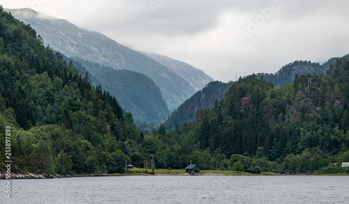 The tops of high mountains on the banks of the fjord in the clouds.  Monstraumen, Hordaland country, Norway, Europe. photo