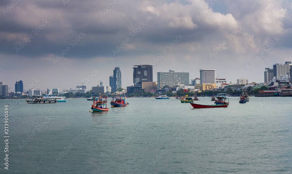 Naklejka premium Fishing boat in Pattaya, Thailand during rainy season