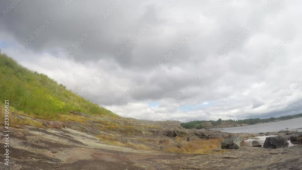 Time Lapse. Rocky coast of Suomenlinna island, Helsinki, Finland. Clouds are floating in the sky. Time Lapse. Rocky coast of Suomenlinna island, Helsinki, Finland. Clouds are floating in the sky.