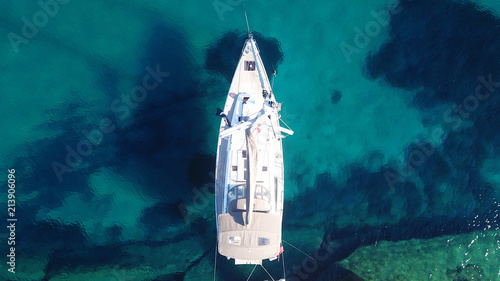 Aerial drone bird's eye top view of luxury sail boat docked in tropical caribbean sea