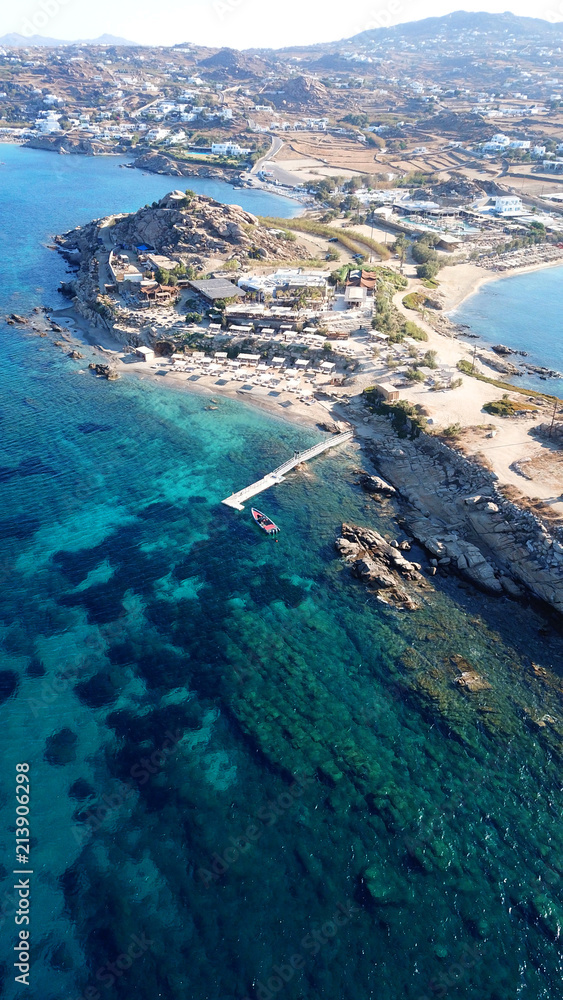 Aerial drone bird's eye view from famous beach of Paraga featuring famous night club of Skorpios and Santanna with largest pool in Europe, Mykonos island, Cyclades, Greece