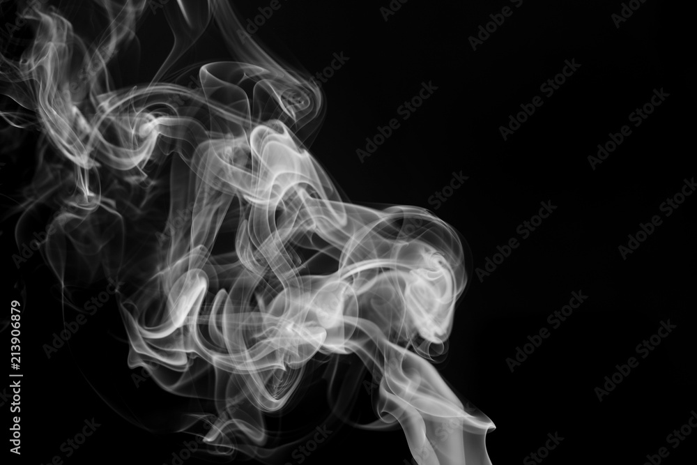 smoke from incense in front of black background smoke from incense in front of black background