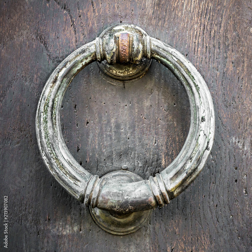 Vintage door knocker on wood