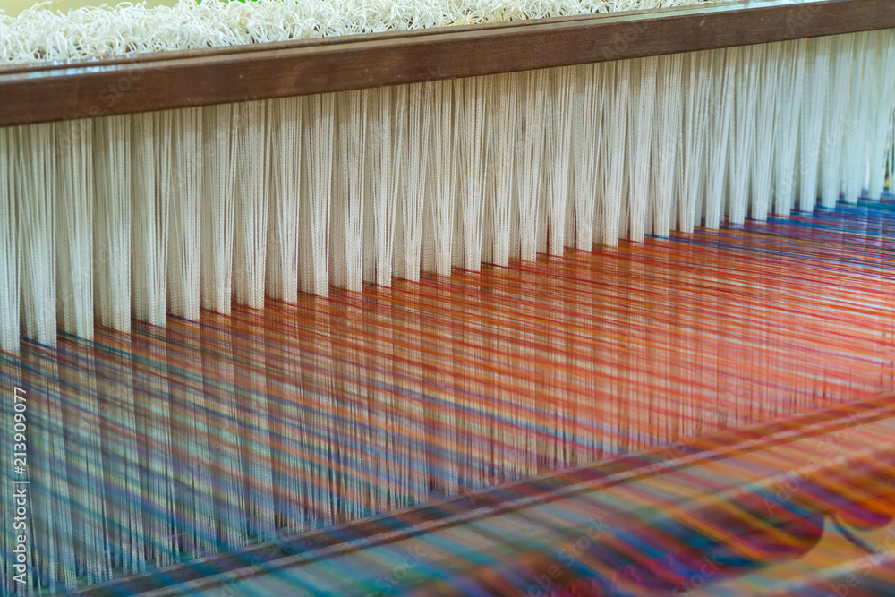 Fototapeta premium Weaving loom and shuttle on the warp