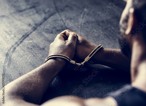 Arrested man with handcuffs on wrists