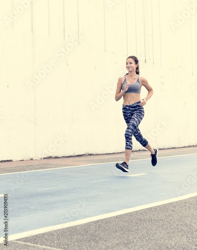 White woman running on track