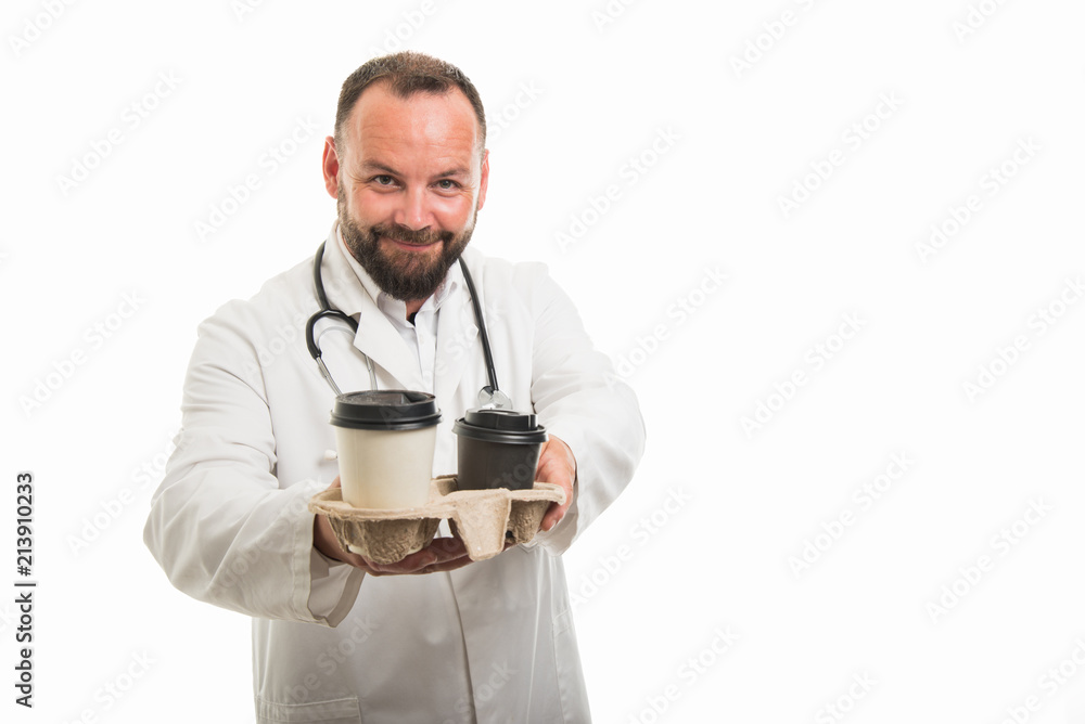Portrait of male doctor offering takeaway coffee
