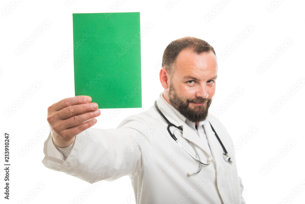 Selective focus of male doctor holding green cardboard Selective focus of male doctor holding green cardboard