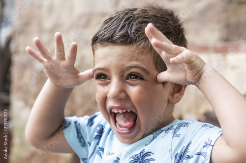 Boy scaring and joking outdoors