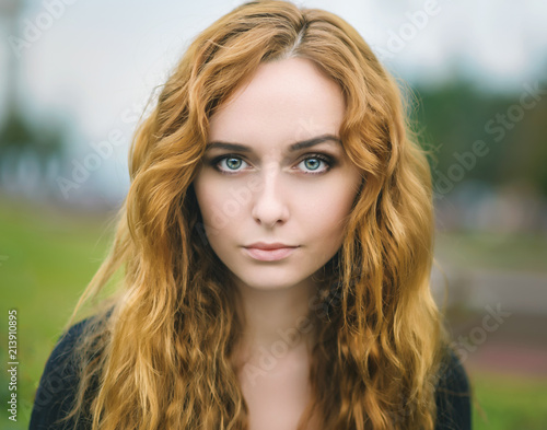 Portrait of attractive young woman with blue eyes.