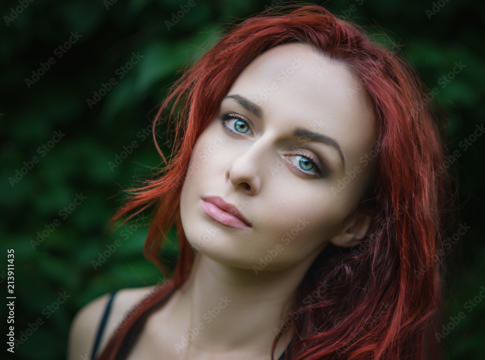 Portrait of attractive red haired young woman with blue eyes. Portrait of attractive red haired young woman with blue eyes.