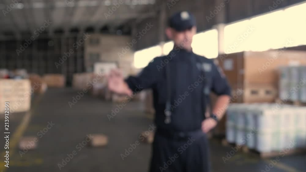 anonymous Polish customs officer talks in the warehouse anonymous Polish customs officer talks in the warehouse