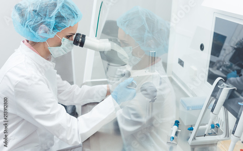 Doctor or scientist working on biotech experiment in laboratory photo