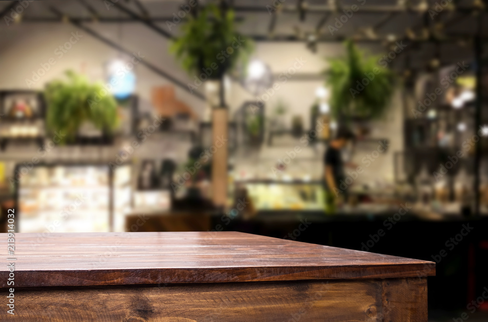 Selected focus empty brown wooden table and Coffee shop or restaurant blur background with bokeh image. for your photomontage or product display Selected focus empty brown wooden table and Coffee shop or restaurant blur background with bokeh image. for your photomontage or product display